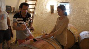 Stéphane Yerle and Cécile Garidou barrel testing wine at their vineyard, Pueche Auriole